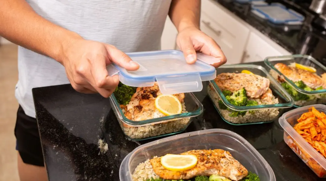 Healthy meal prep with chicken, broccoli, and rice in containers.