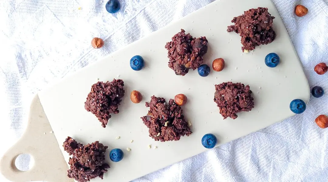 Blueberry and chocolate clusters on a white board