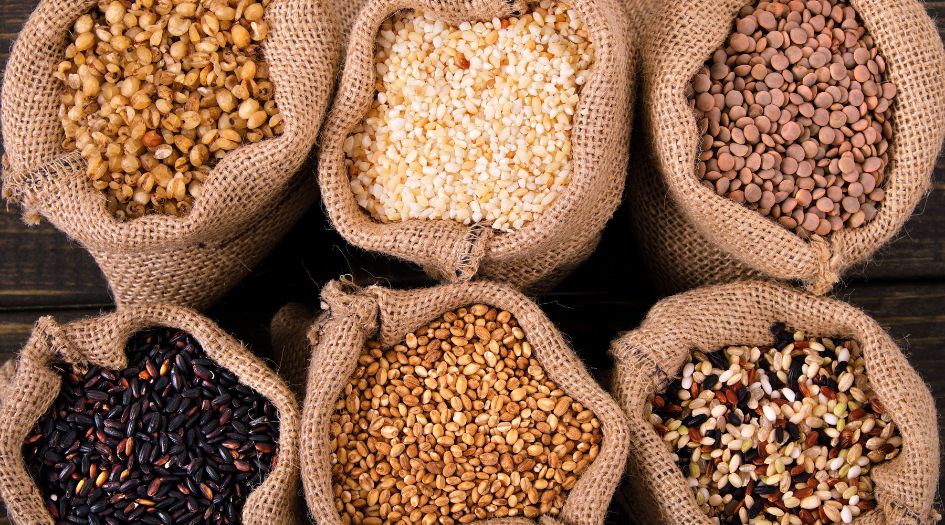 various types of grains in sacks on a wooden table