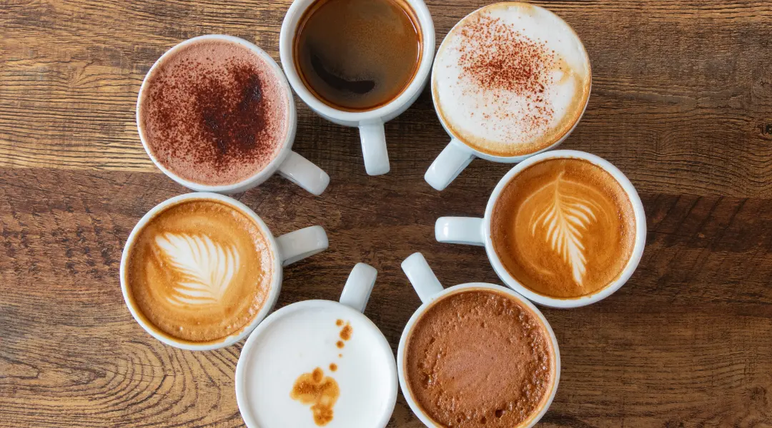 a group of coffee cups arranged in a circle on a wooden table
