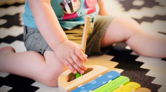 Obese child playing xylophone