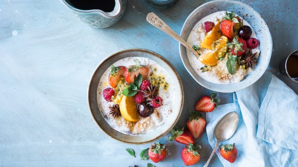 two bowls of oatmeal with fruits