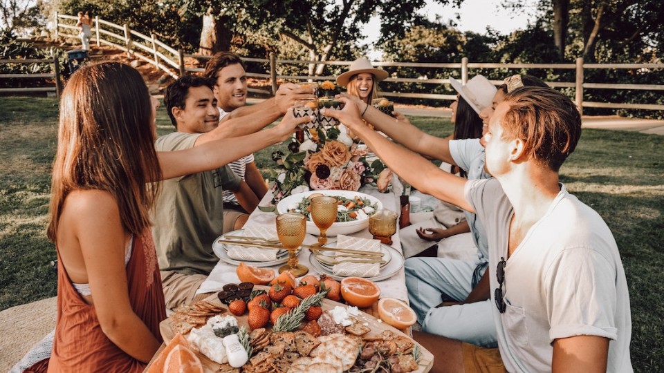 festive young adults celebrating by eating out