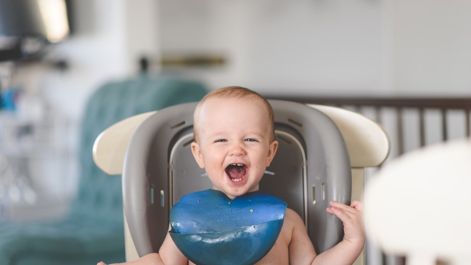 smiling baby in highchair