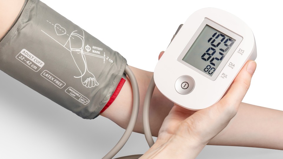 Adult blood pressure monitor in use
