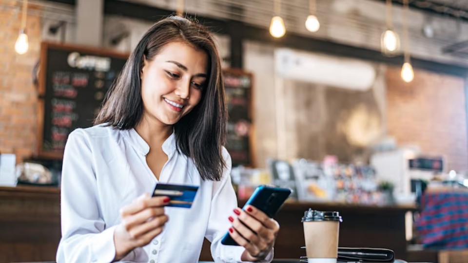 Woman giving her credit card number over the phone to book an appointment with a registered dietitian