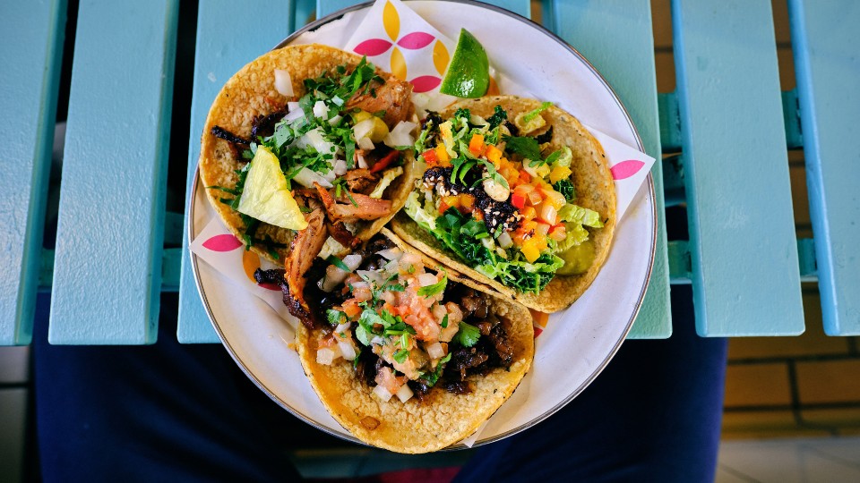 3 shrimp tacos served on a plate