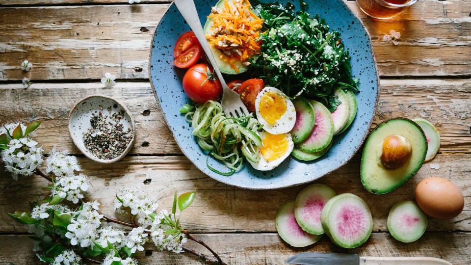 bowl with tomatoes, egg and greens