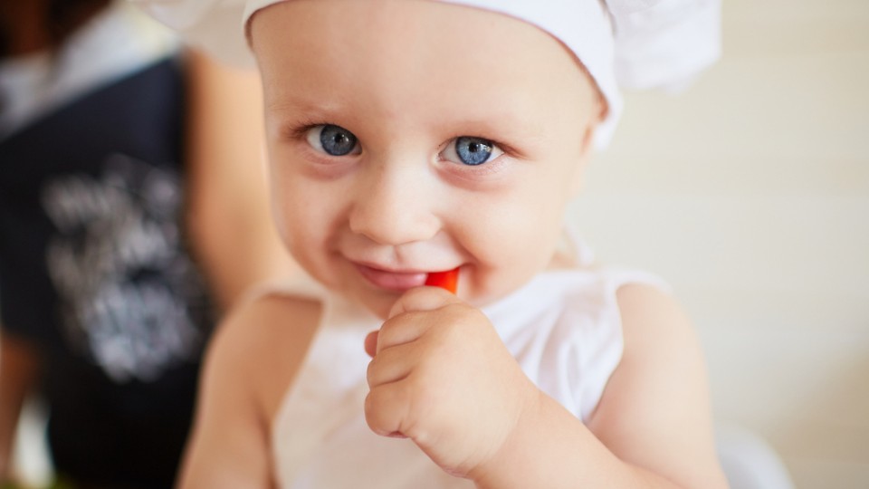 blue-eyed child in a chef's hat