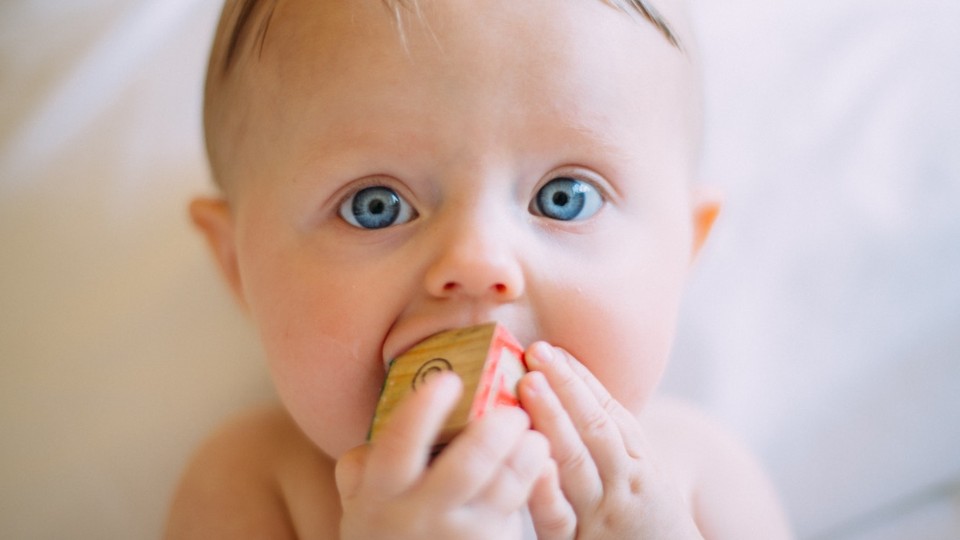 Blue-eyed baby who is teething