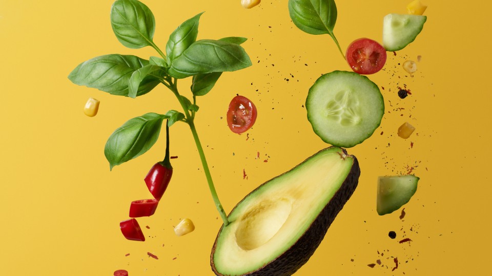 avocado, cucumber, tomatoes, basilic on a yellow background