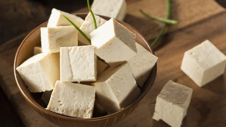 Small tofu cubes in a small wooden bowl