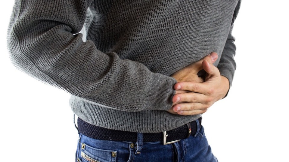 Man with a grey shirt having bloating