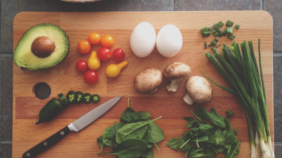 vegetables and proteins on a wooden cutting board