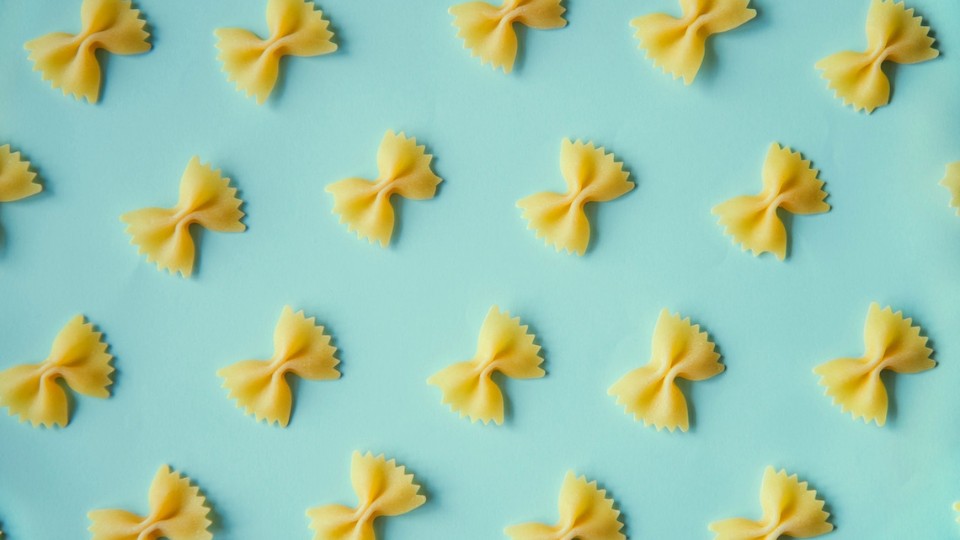 looped pasta on a pale blue background