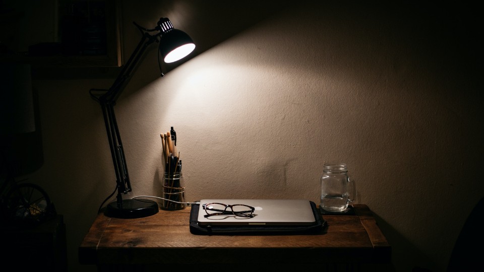 work desk illuminated by a lamp
