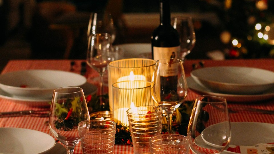 meal on the table with bottle of wine and candle