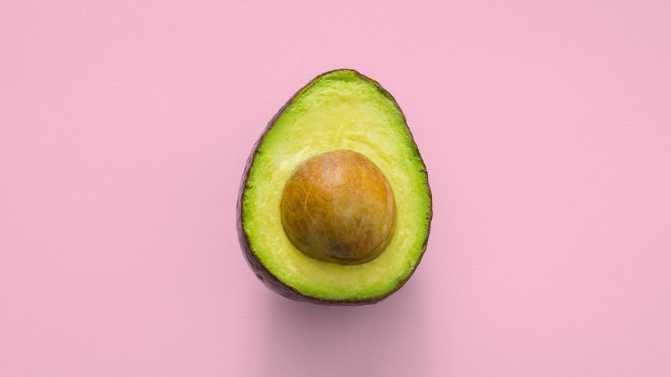 avocado in front of a pink background