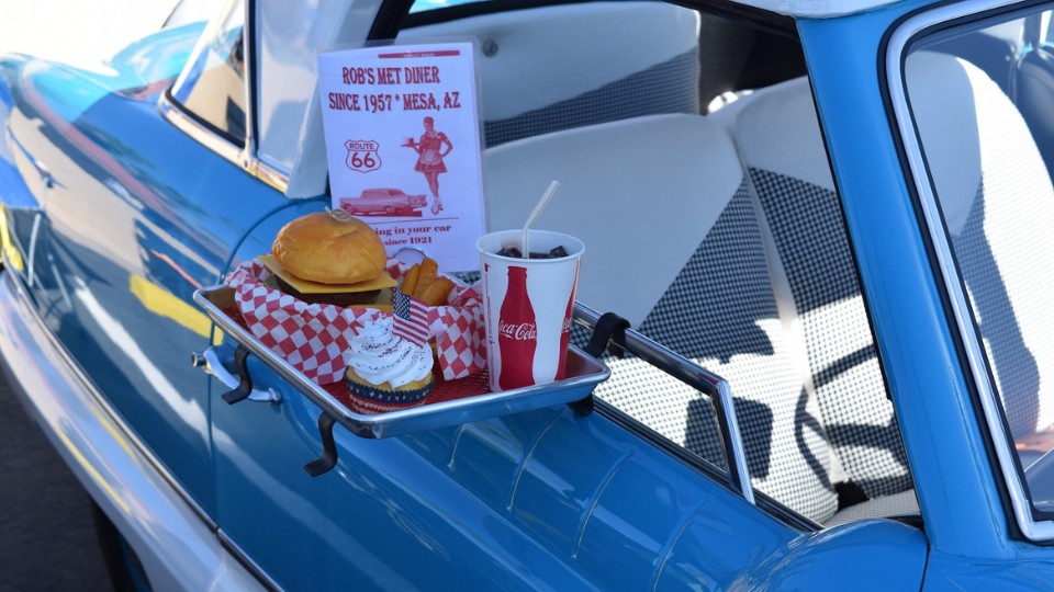 Burger and fries being served at a drive thru