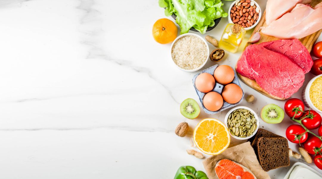 an assortment of healthy foods arranged on a marble surface