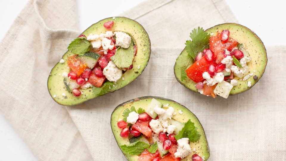 Three avocados stuffed with feta, tomatoes and mint 