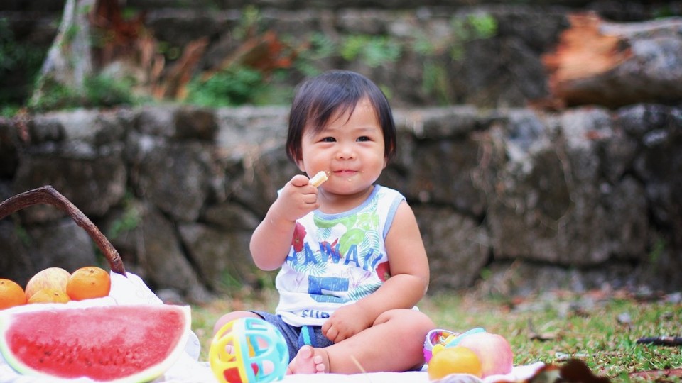 child eating at a picnic