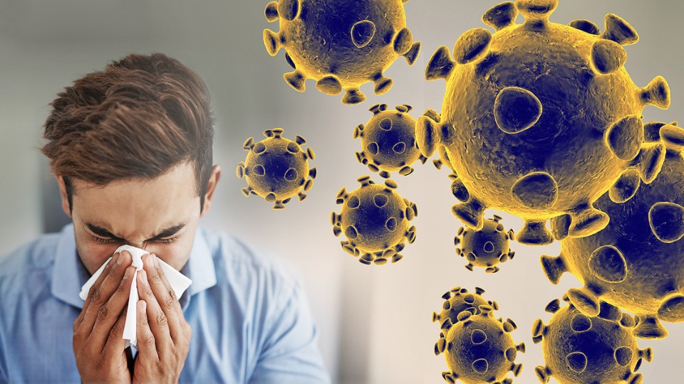 a man blowing his nose beside coronavirus