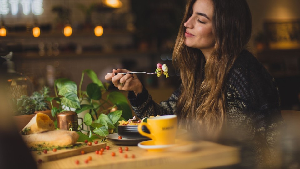 a woman eating vegetables