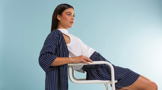 Woman sitting on a chair with FIG clothing