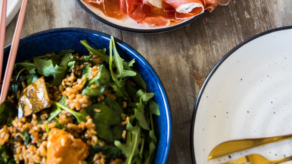 Arugula salad with prosciutto on a table