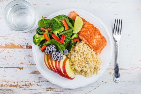 Plate with salmon, rice, salad and apple