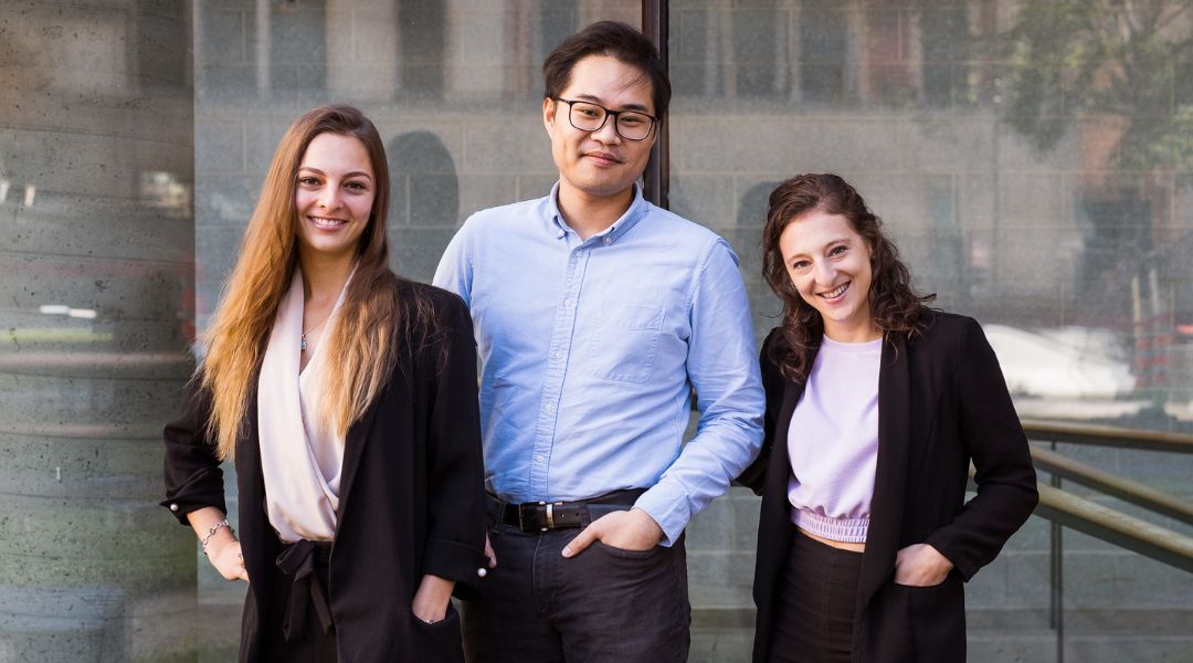 Three registered dietitians smiling confidently outdoors, dressed in business casual attire