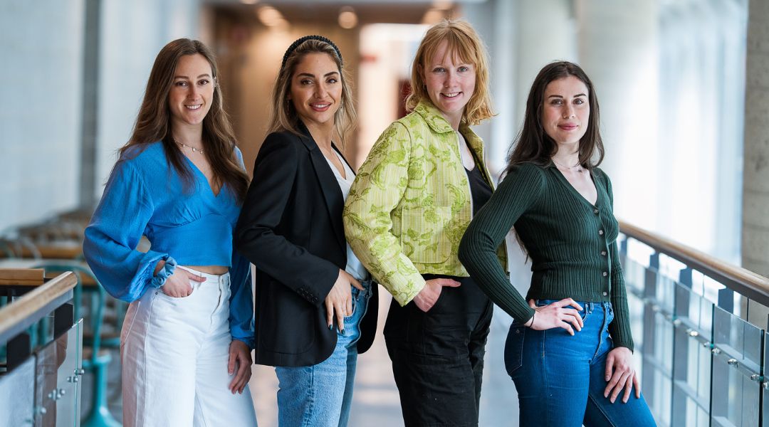 Four TeamNutrition dietitians standing side by side, posing confidently in a bright indoor space