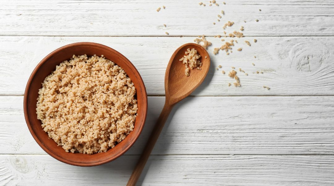 a bol of quinoa with a wooden spoon