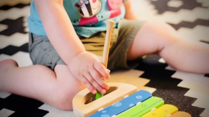 Obese child playing xylophone