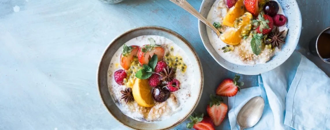 two bowls of oatmeal with fruits