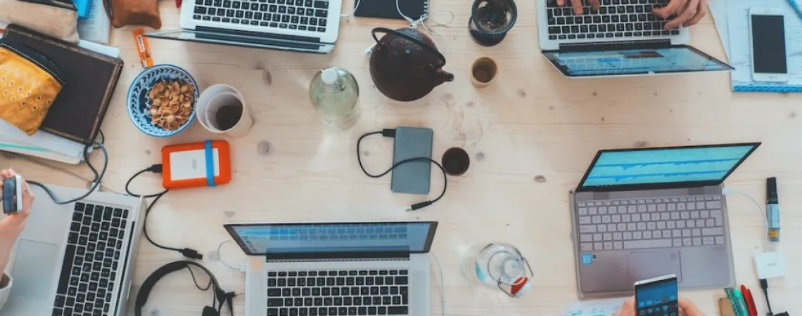Ordinateurs et portables sur un bureau avec café
