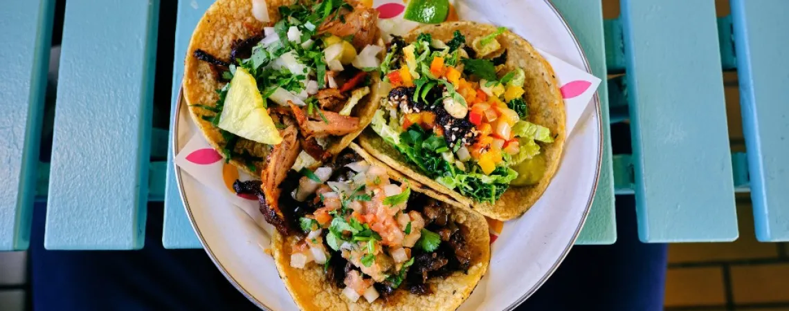 3 shrimp tacos served on a plate
