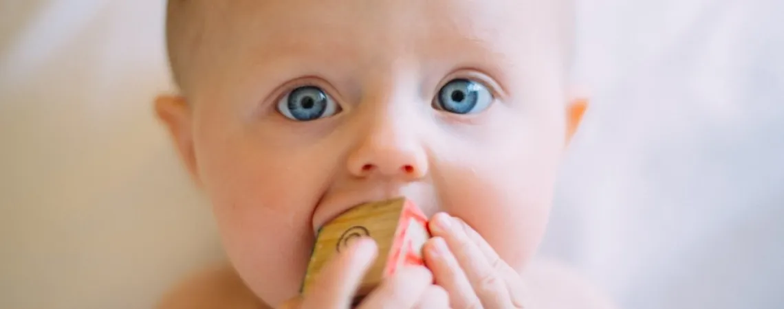 Blue-eyed baby who is teething