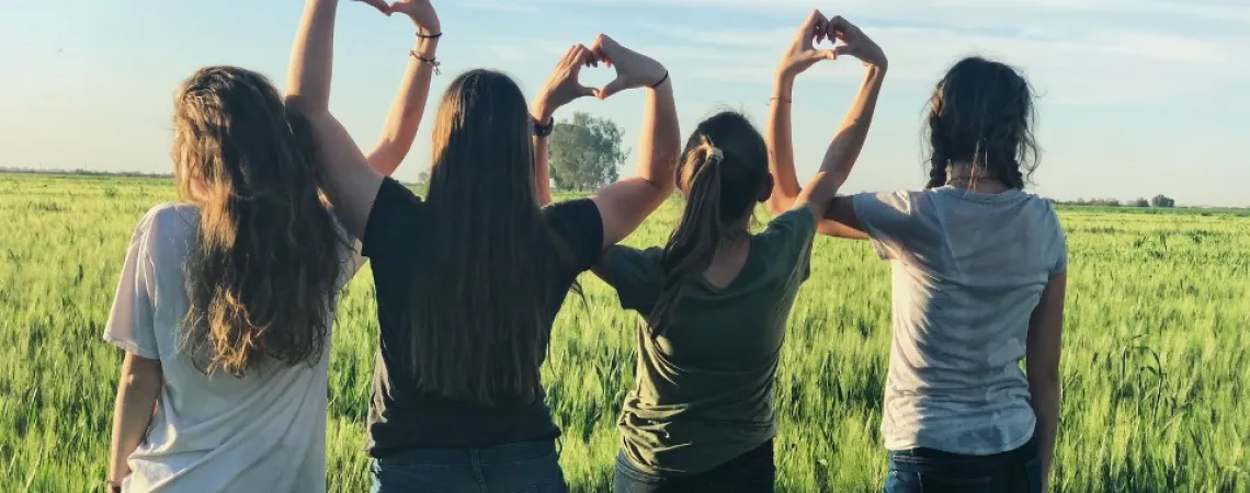 4 teenage girls in a field
