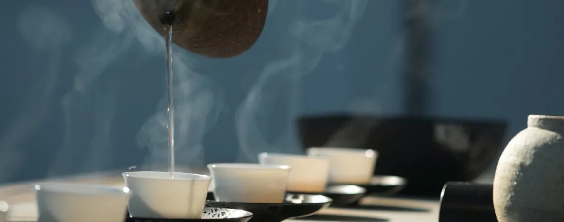 Withe cups of tea in black plates