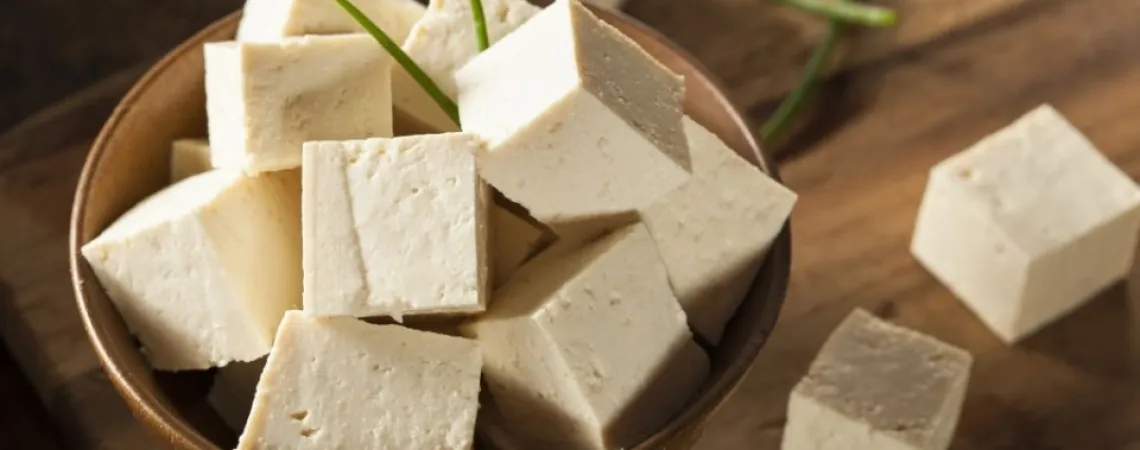 Small tofu cubes in a small wooden bowl