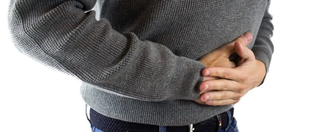 Man with a grey shirt having bloating
