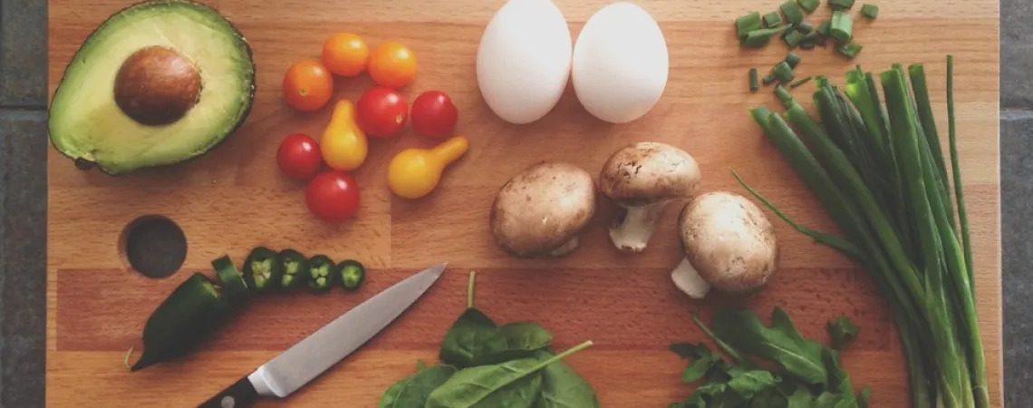 vegetables and proteins on a wooden cutting board