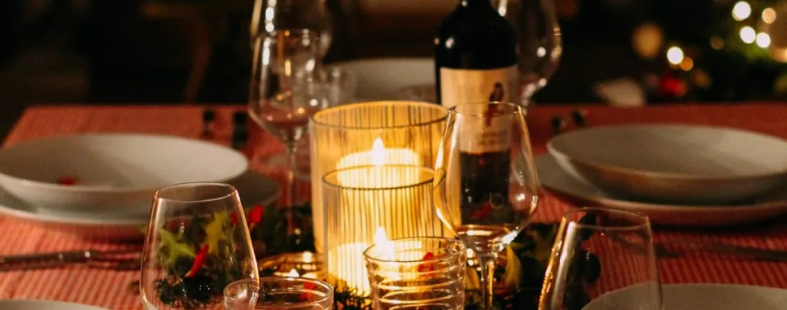 meal on the table with bottle of wine and candle