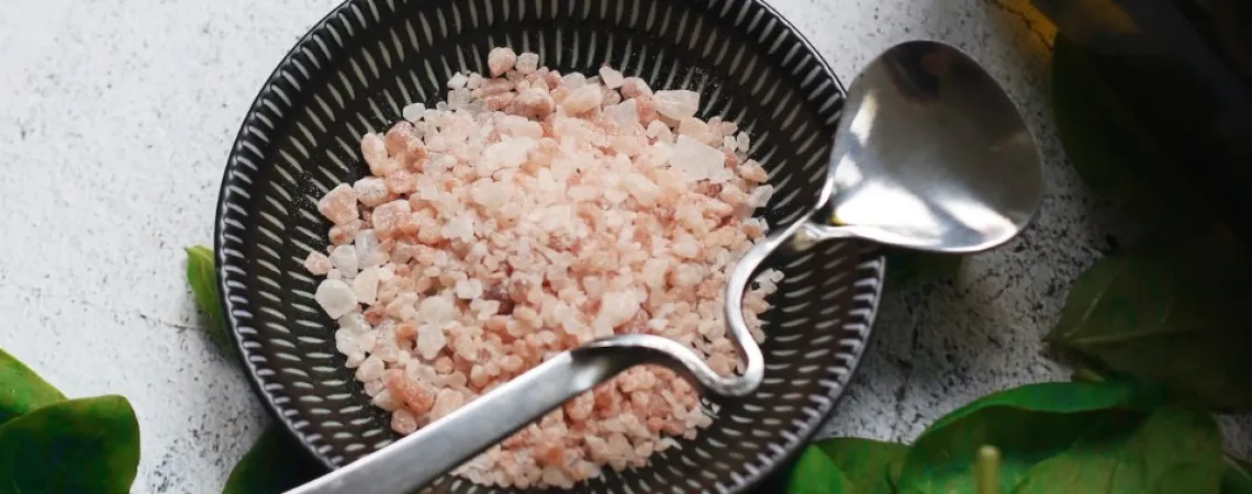 bowl of Himalayan salt with spinach on the side