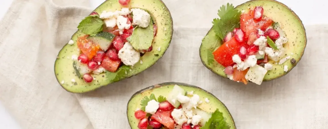 Three avocados stuffed with feta, tomatoes and mint