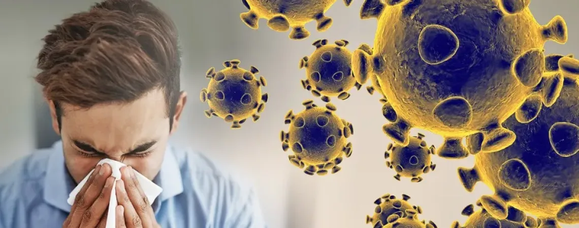 a man blowing his nose beside coronavirus