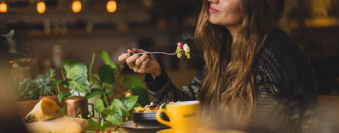a woman eating vegetables