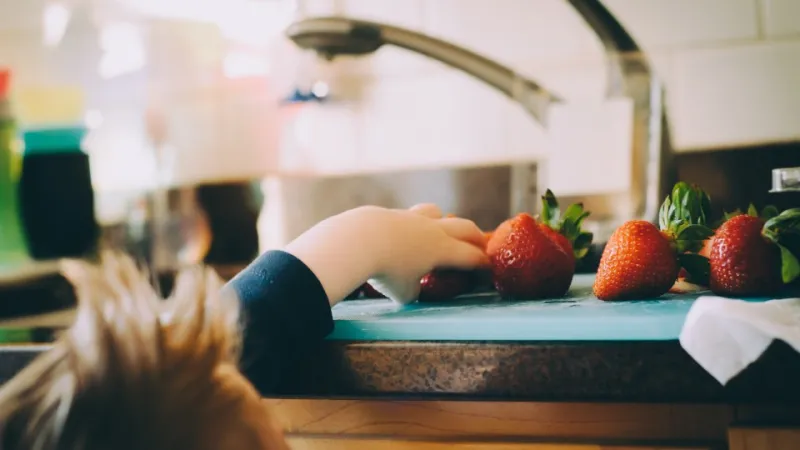kid and strawberries